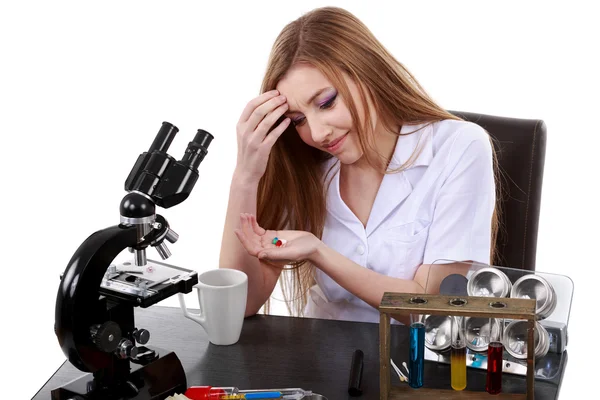Woman scientist who takes pills for migraine — Stock Photo, Image