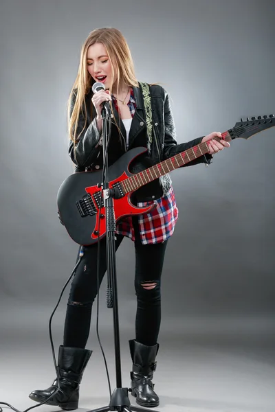 Bella giovane donna bionda con una chitarra elettrica — Foto Stock