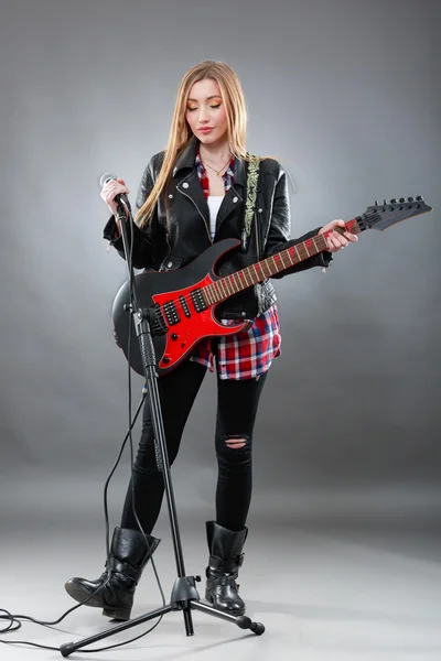 Όμορφη νεαρή, ξανθιά γυναίκα με μια ηλεκτρική κιθάρα — Φωτογραφία Αρχείου