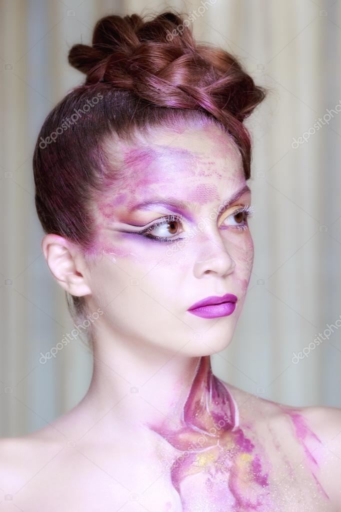 Portrait of young woman with creative make-up in spring style