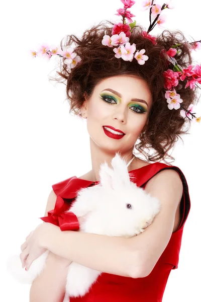 Mujer con un conejo, huevos y flores primavera Pascua concepto —  Fotos de Stock