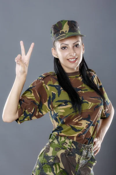 Portrait of cheerful female soldier gesturing peace sign — Stock Photo, Image