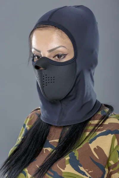 Female soldier in camouflage outfit and mask — Stock Photo, Image