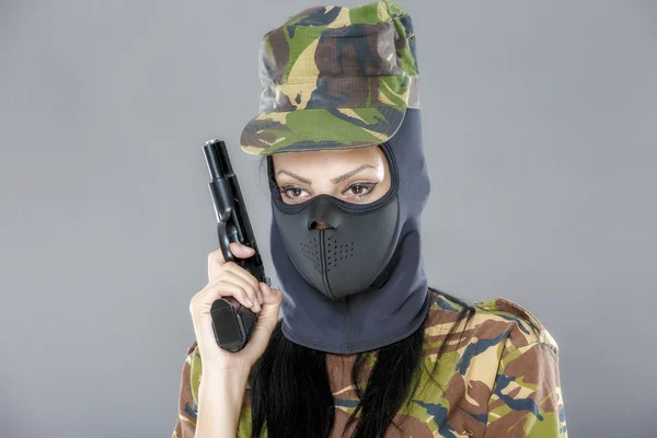 Female soldier in camouflage uniform with weapon isolated on gray background — Stock Photo, Image