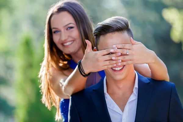 Photo of a woman covering the eyes of a man — Stock Photo, Image