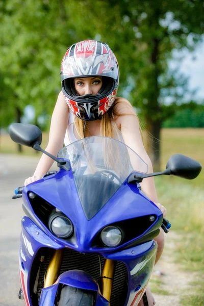 Beautiful young woman with a motorcycle speed in nature — Stock Photo, Image