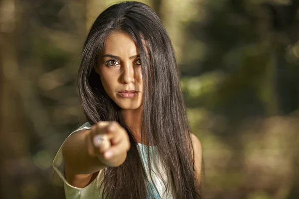 Closeup portrait of young angry woman pointing at someone as if — Stock Photo, Image