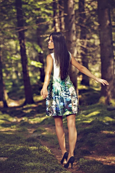 Beautiful young fashion woman in color dress posing outdoor in g — Stock Photo, Image