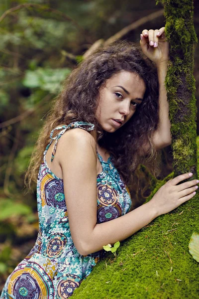 Portrait of a beautiful woman with curly hair in nature — Stock Photo, Image