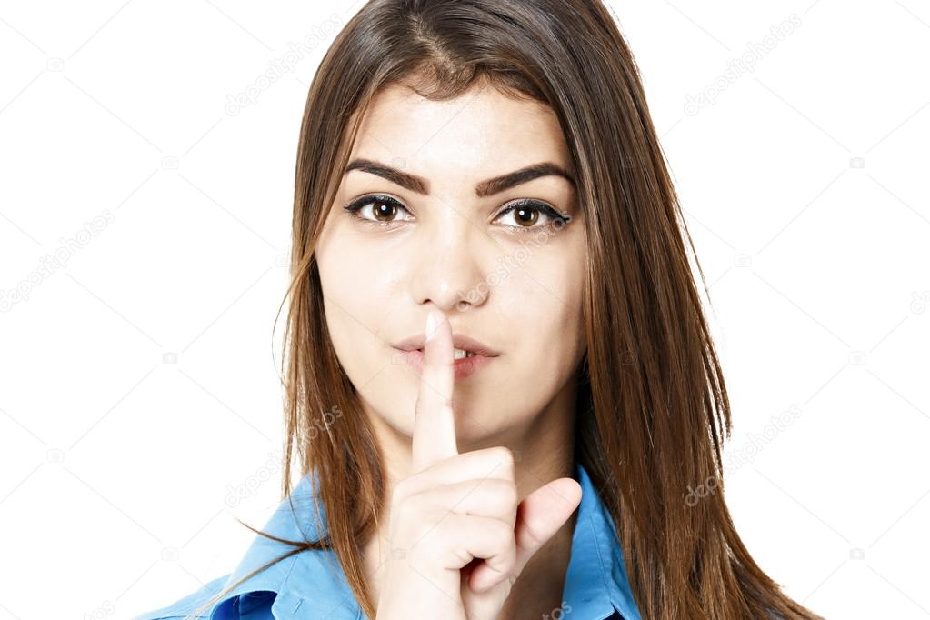 pretty woman making silence sign over white background