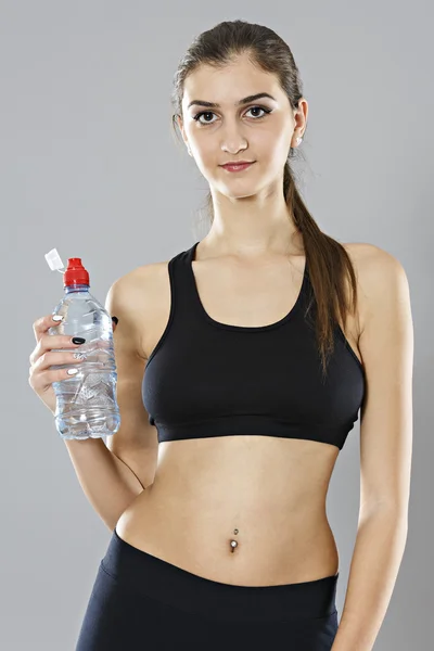 Portrait of a healthy woman with bottle of water. Healthy lifest — Stockfoto