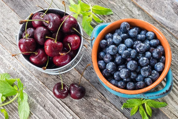 Cherry and Blueberry on a wooden table — Stock Photo, Image