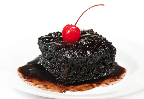 Brownie-Kuchen mit einer Kirsche lizenzfreie Stockfotos