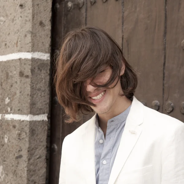 Teenage model struggling with his long hair — Stock Photo, Image