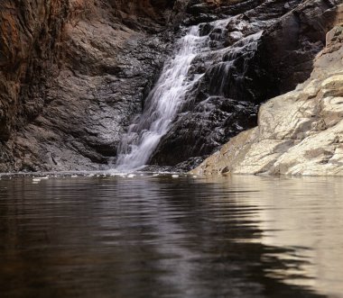 Gran Canaria, adanın güney kesimindeki çılgın Barranco del Toro çevresindeki yürüyüş rotası boyunca uzanan manzaralar, mağaralar ve mağaralarla dolu, San Agustin tatil köyüne yakın, kış yağmurlarından sonra vadide sular akıyor.