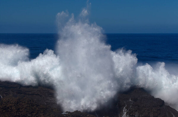 Gran Canaria, north coast, area around Punta Sardina cape, powerful foamy ocean waves breaking along the shore