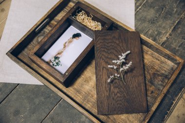 wooden box for photos with a photograph lying on a wooden tray beautiful stylized stylish fine art under the film with beautiful photography