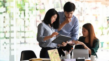 Bunlar hakkında konuşan / tartışan / beyin fırtınası yapan / görüşen / planlayan genç iş geliştirme ekibinin fotoğrafı modern ofis / toplantı odasıyla toplantı masasında son buluyor.