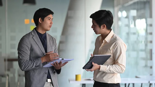 Photo of young business consulting man while talking/giving an advice to customer.