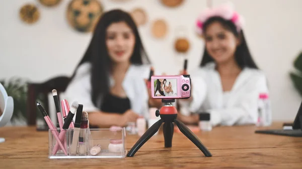 Beauty blogger concept, Selective focus camera being shown cheerful delighted beauty blogger.