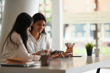 Ofis çalışanları beyaz çalışma masasında iş konuşuyorlar..