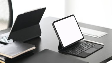 Modern dark surface office desk with computer laptop and notebook.