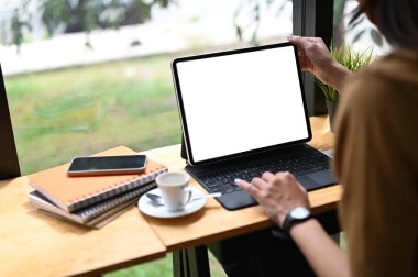 Cropped shot of an office worker using a computer tablet with white screen in office.