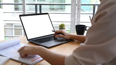 Bilgisayarla çalışan ve finansal ve pazarlama belgelerini analiz eden iş kadınının görüntüsü..