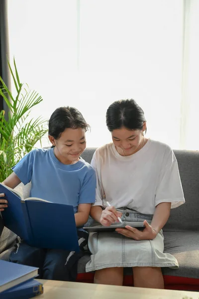 Two Happy Asian Girl Using Digital Tablet Together Siting Sofa — Stok fotoğraf