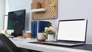 Laptop bilgisayar ve ofis malzemeleri olan ofis masası..