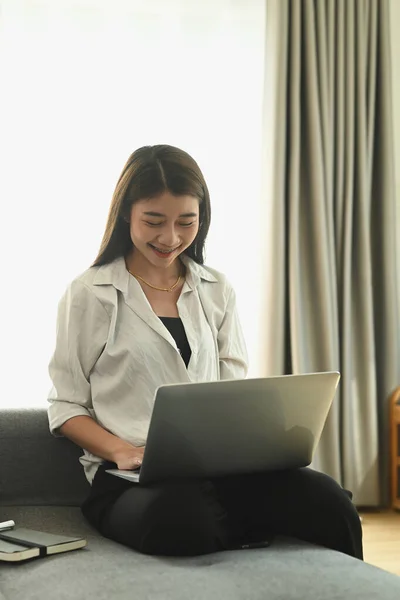 Happy Young Female Using Laptop Computer While Sitting Sofa Comfortable — Zdjęcie stockowe