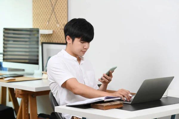 Young Man Employee Working Laptop Computer Using Mobile Phone Home — Φωτογραφία Αρχείου