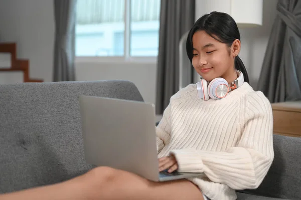 Young Woman Headphone Sitting Sofa Surfing Internet Laptop — Stockfoto