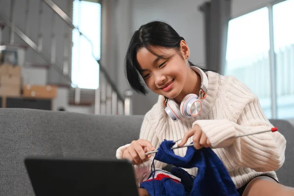 Happy Young Girl Enjoying Knitting Watching Something Digital Home — Stockfoto