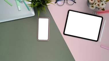 İki ton arkaplan üzerinde beyaz ekran tableti ve akıllı telefonun üst görünümü.