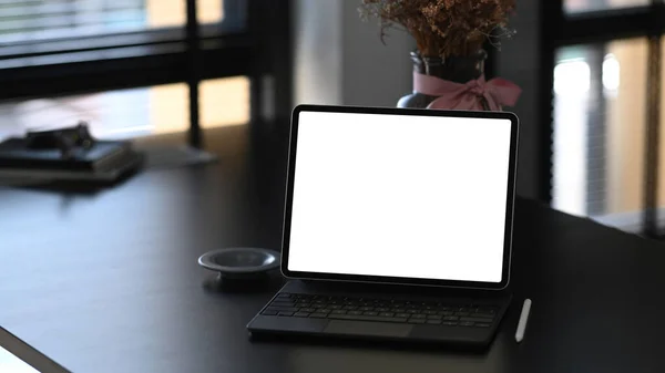 Modern workspace with a blank screen computer tablet. Blank screen for graphics display montage.