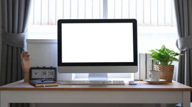 Tahta masadaki beyaz ekranlı ön görünüm bilgisayarı.