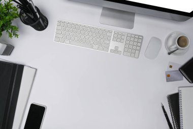 Beyaz masa üzerinde bilgisayar ve ofis malzemeleri olan modern çalışma alanının üstünde..