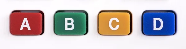 Knappar med mångfärgade bokstäverna A, B, C, D — Stockfoto
