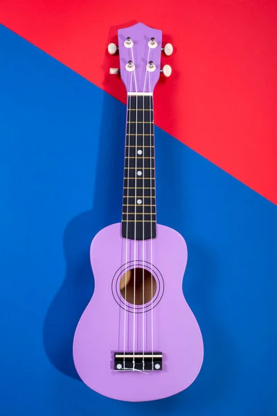 Four String Ukulele Guitar Blue Red Background — Stock Photo, Image