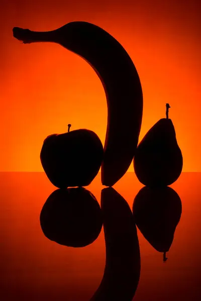Silhouette Aus Banane Birne Und Apfel Auf Rotem Hintergrund — Stockfoto