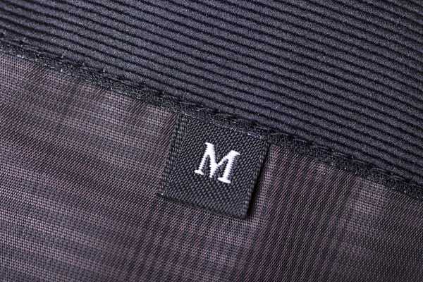 The tag size designation of clothes with the letter M — Stock Photo, Image