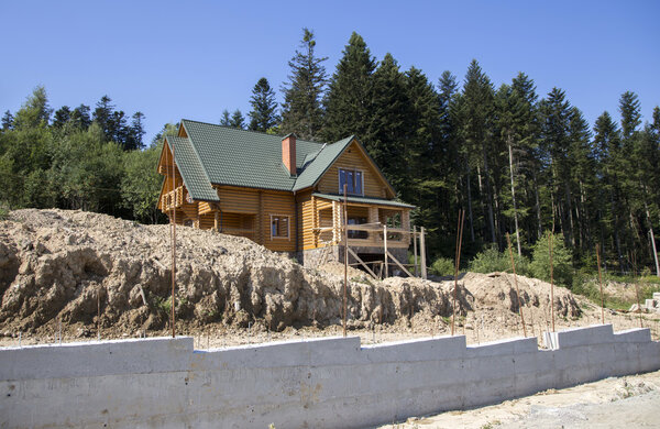 Construction of a wooden cottage in the forest area