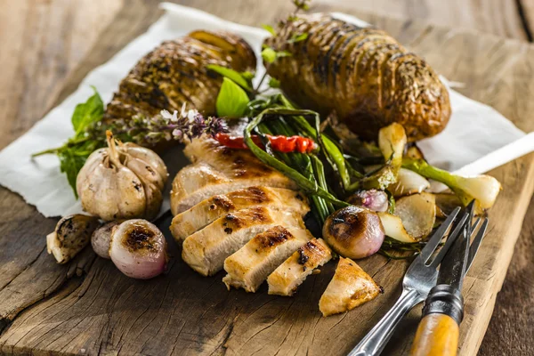 Chicken breast on wood plate — Stock Photo, Image