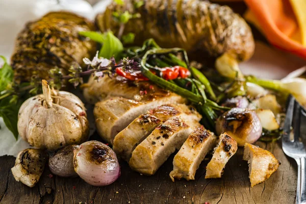 Chicken breast on wood plate — Stock Photo, Image