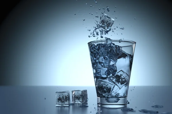 Ice cube splash in a glass water — Stock Photo, Image