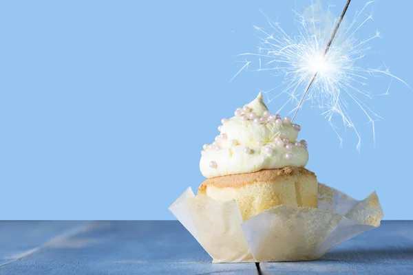 Cupcake with a glittering sparkler — Stock Photo, Image