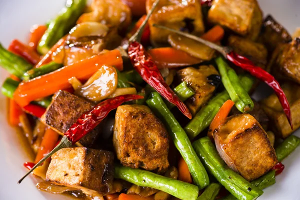 Primer plano de un tazón de tofu y verduras salteado . Imagen De Stock