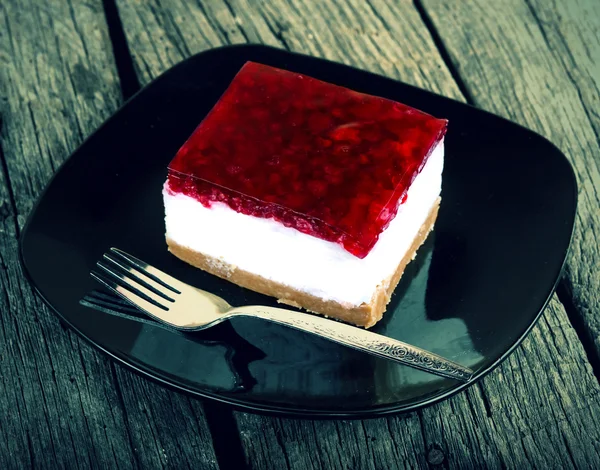 Cheesecake on old wood table vintage effect photo — Stock Photo, Image