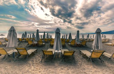 Lounge şezlong ve şemsiye plajda tropik gündoğumu sabah